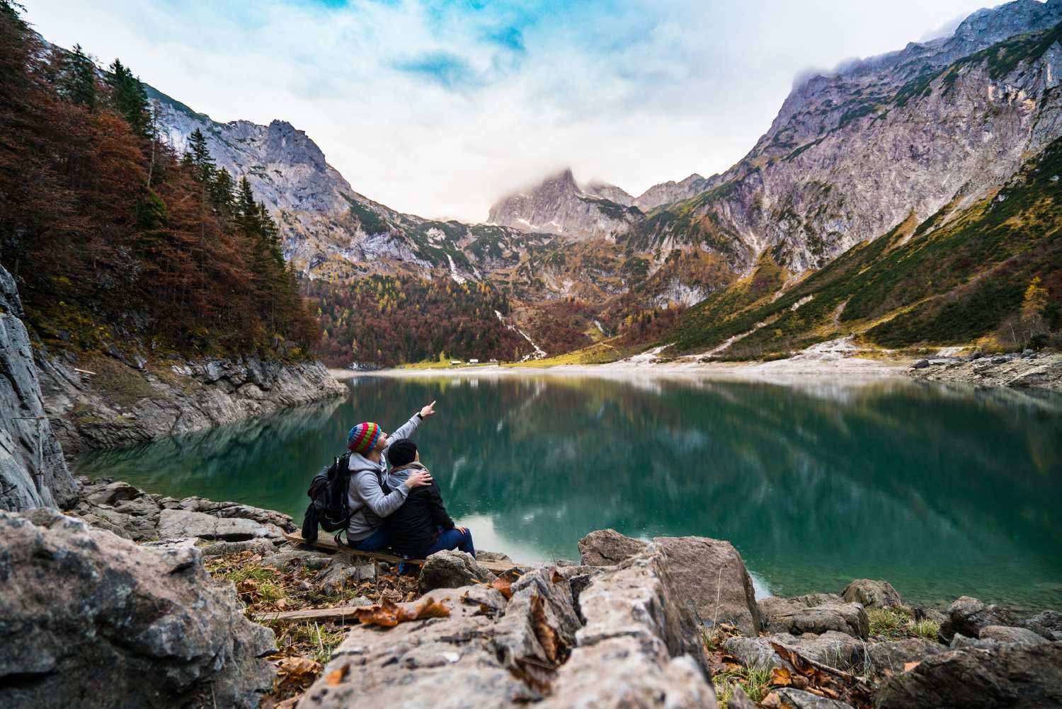 Adventurer pointing towards a mountain