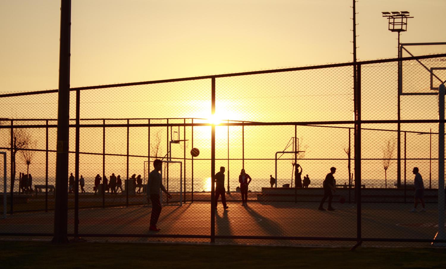 Basketball players at sunset