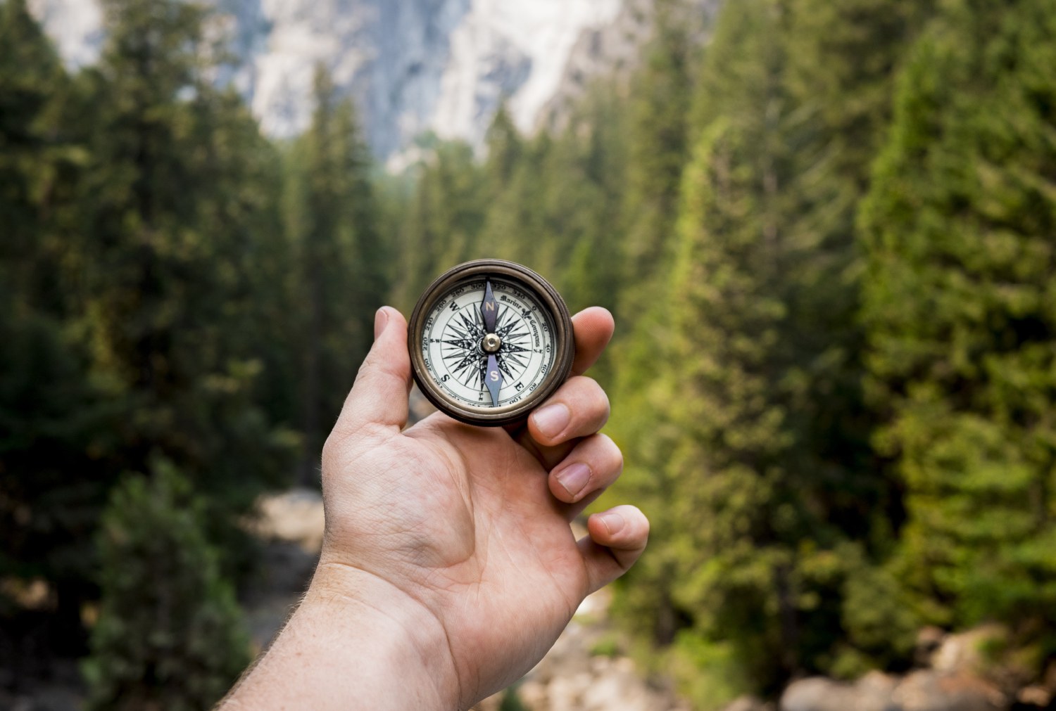 Freedom of purpose represented by hiking in forest with compass